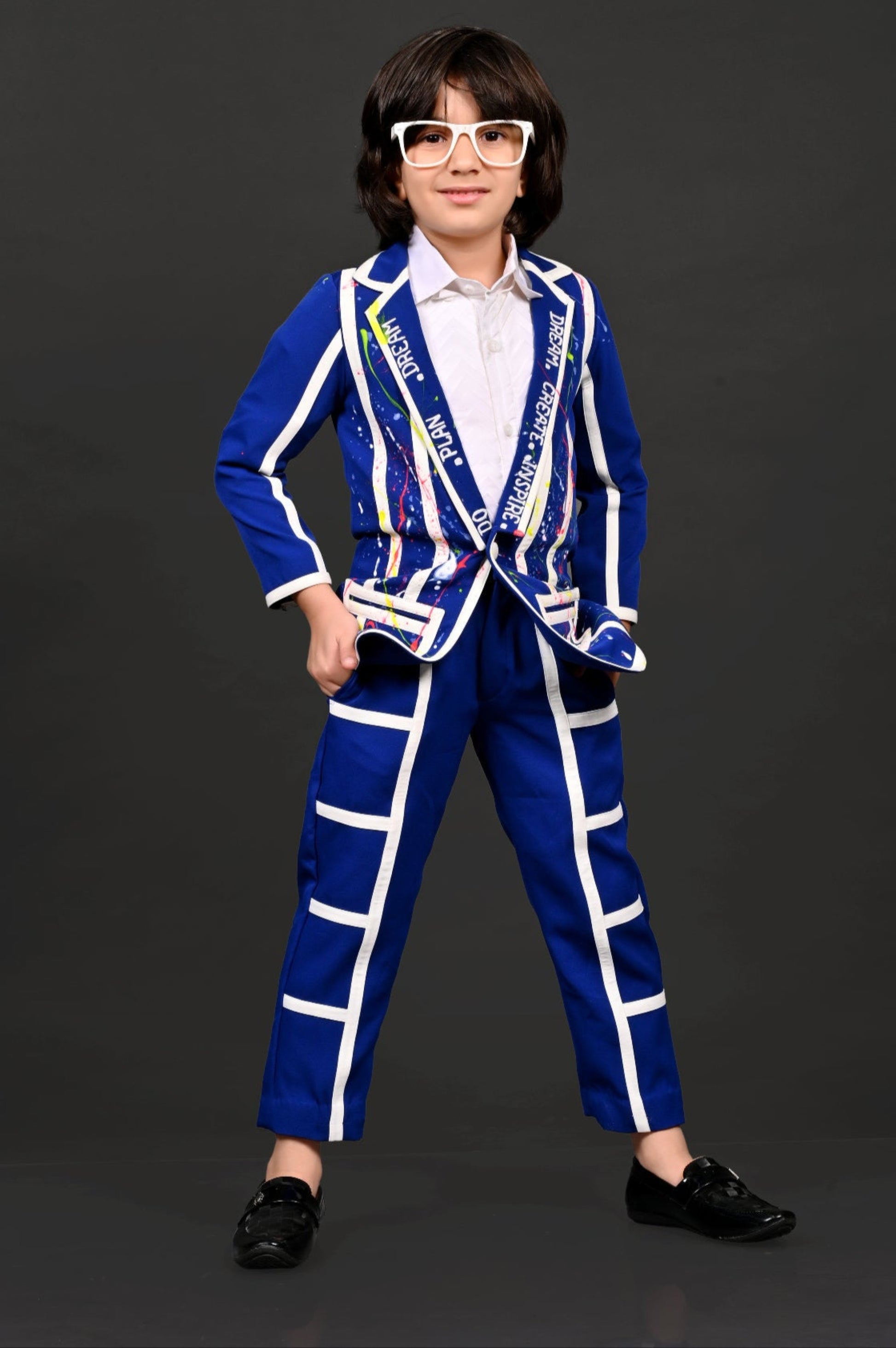 Person wearing a blue and white suit with a sash on a black background